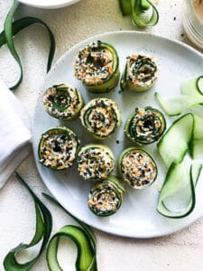 Low-carb cucumber ribbons rolled with deli turkey and hummus.